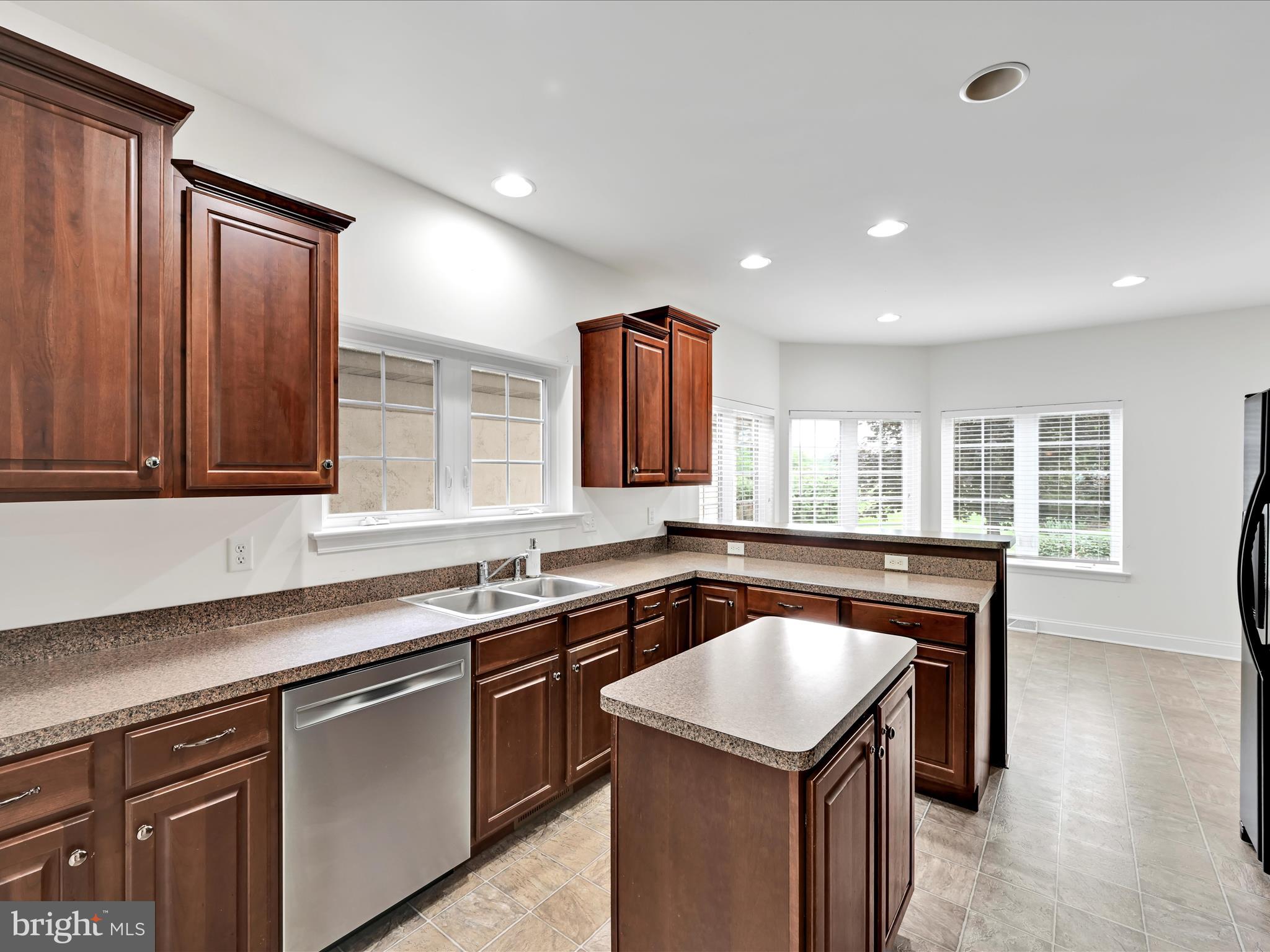 660 Woodfield Drive Lititz, PA 17543 - Photo 9 of 43 a kitchen that has a sink a stove counter top space and cabinets