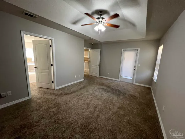 a bathroom with a granite countertop sink mirror vanity bathtub and toilet