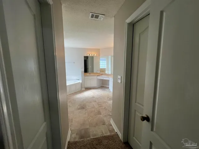 a view of entryway with window and a bathroom