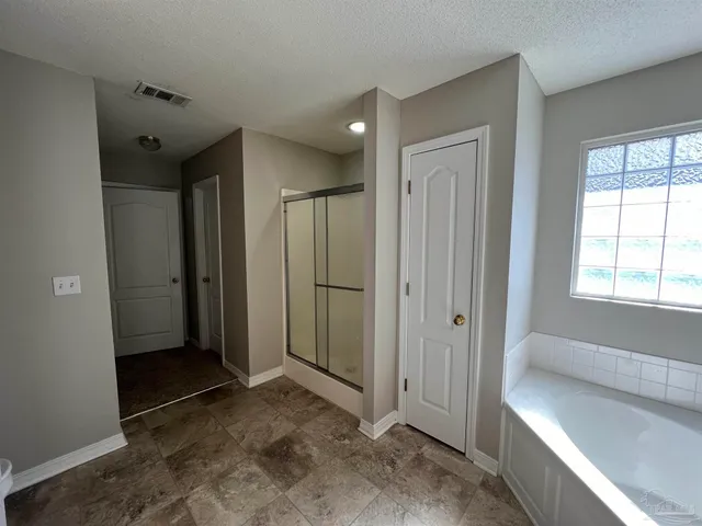 wooden floor in an empty room with a large window