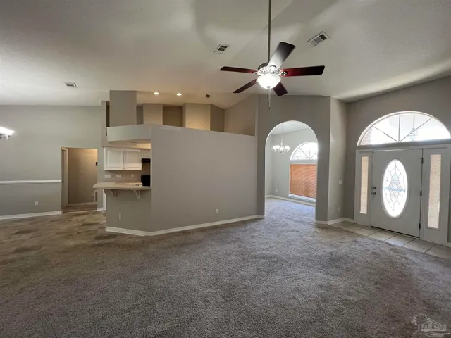a view of a livingroom with a ceiling fan and window