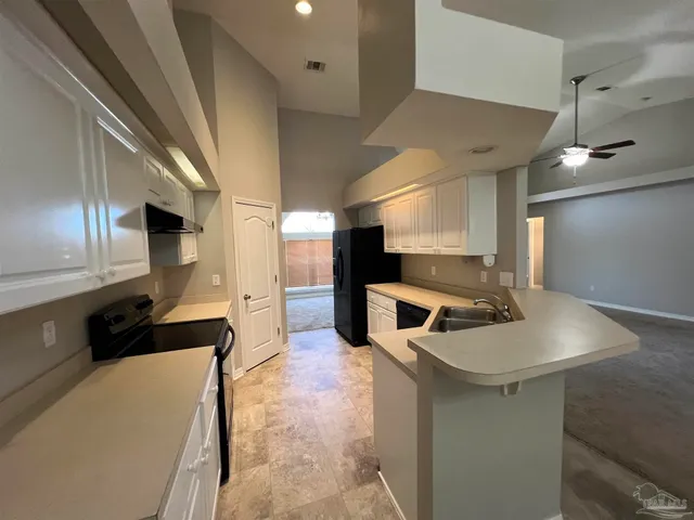 a kitchen with a sink stainless steel appliances and cabinets
