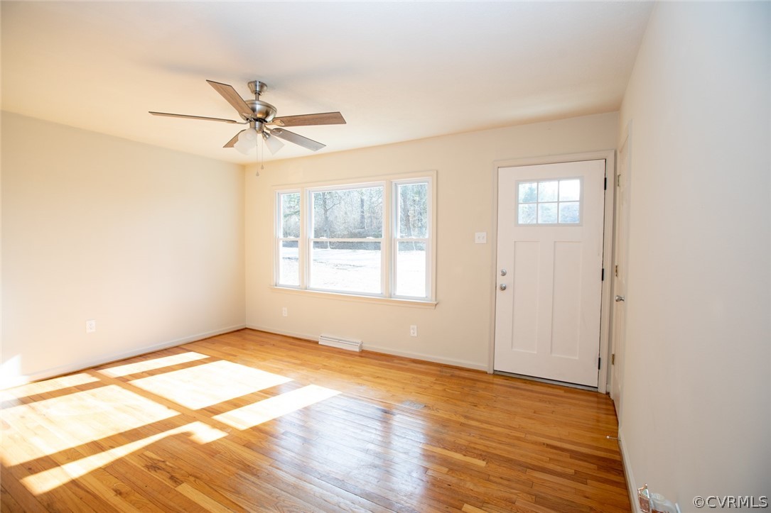 3488 Meherrin Road Meherrin, VA 23954 - Photo 7 of 50 a view of an empty room with wooden floor and a window