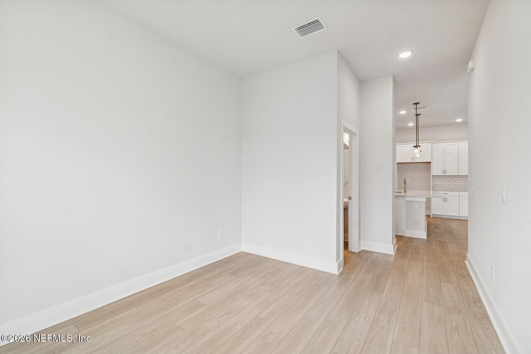 10131 Element Road Jacksonville, FL 32256 - Photo 13 of 28 a view of a kitchen with a refrigerator and wooden floor