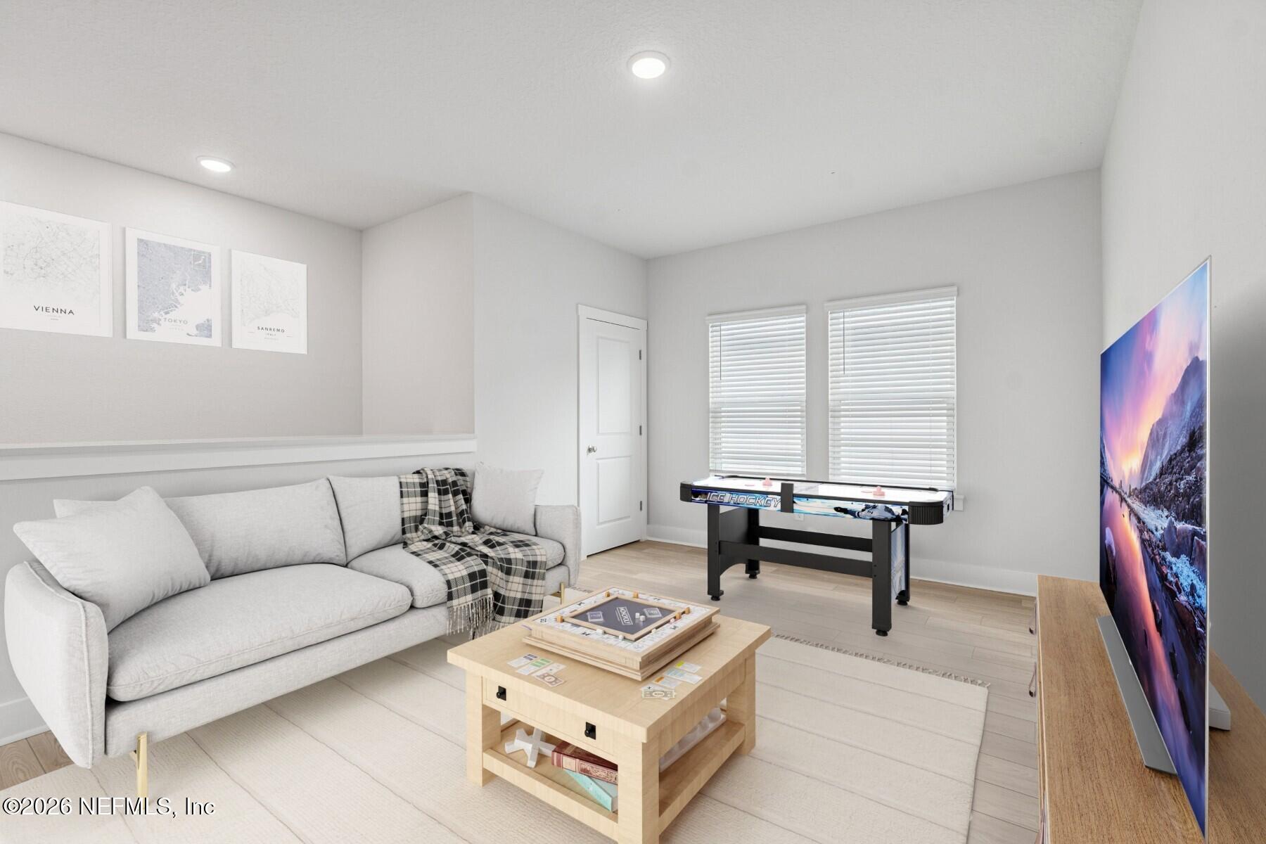 10131 Element Road Jacksonville, FL 32256 - Photo 16 of 28 a living room with furniture a flat screen tv and a window
