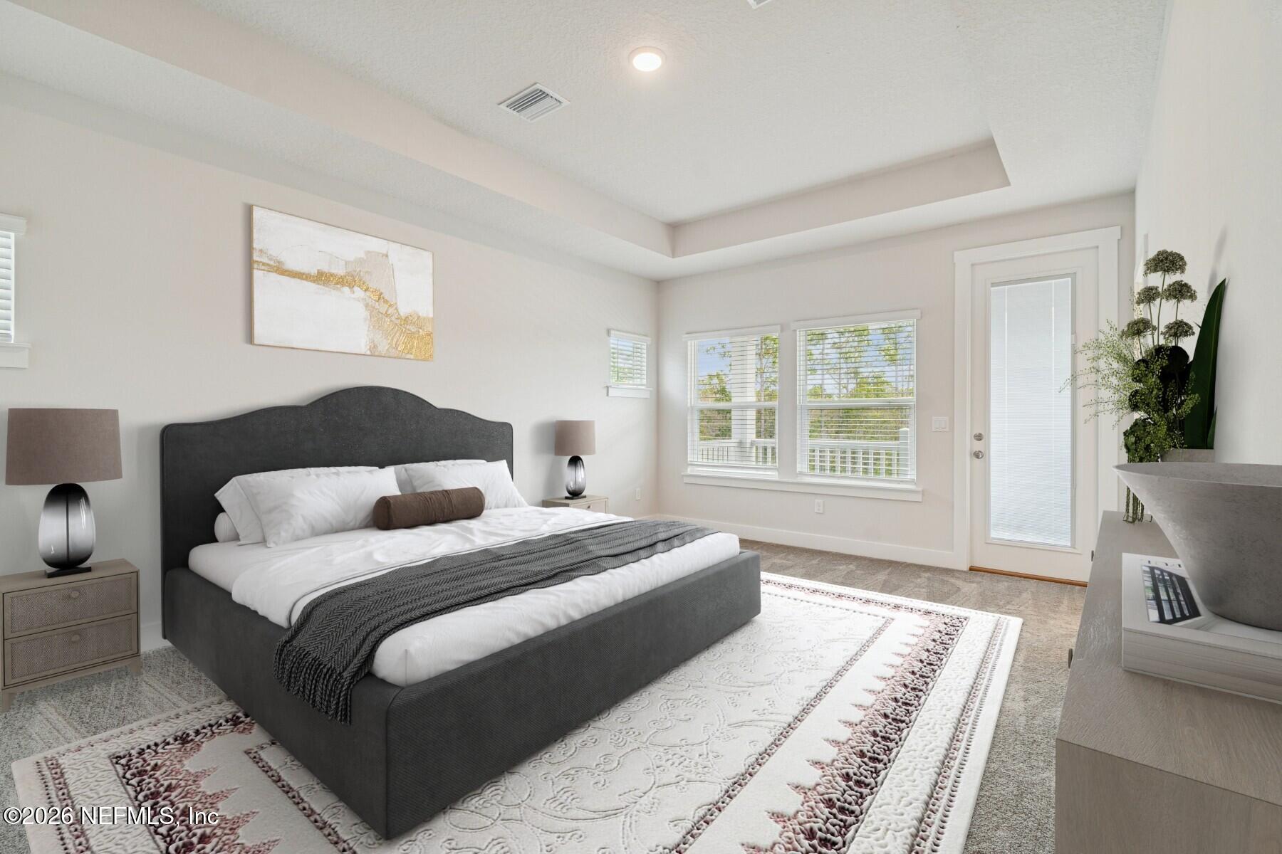 10131 Element Road Jacksonville, FL 32256 - Photo 18 of 28 a bedroom with a large bed couch and a window