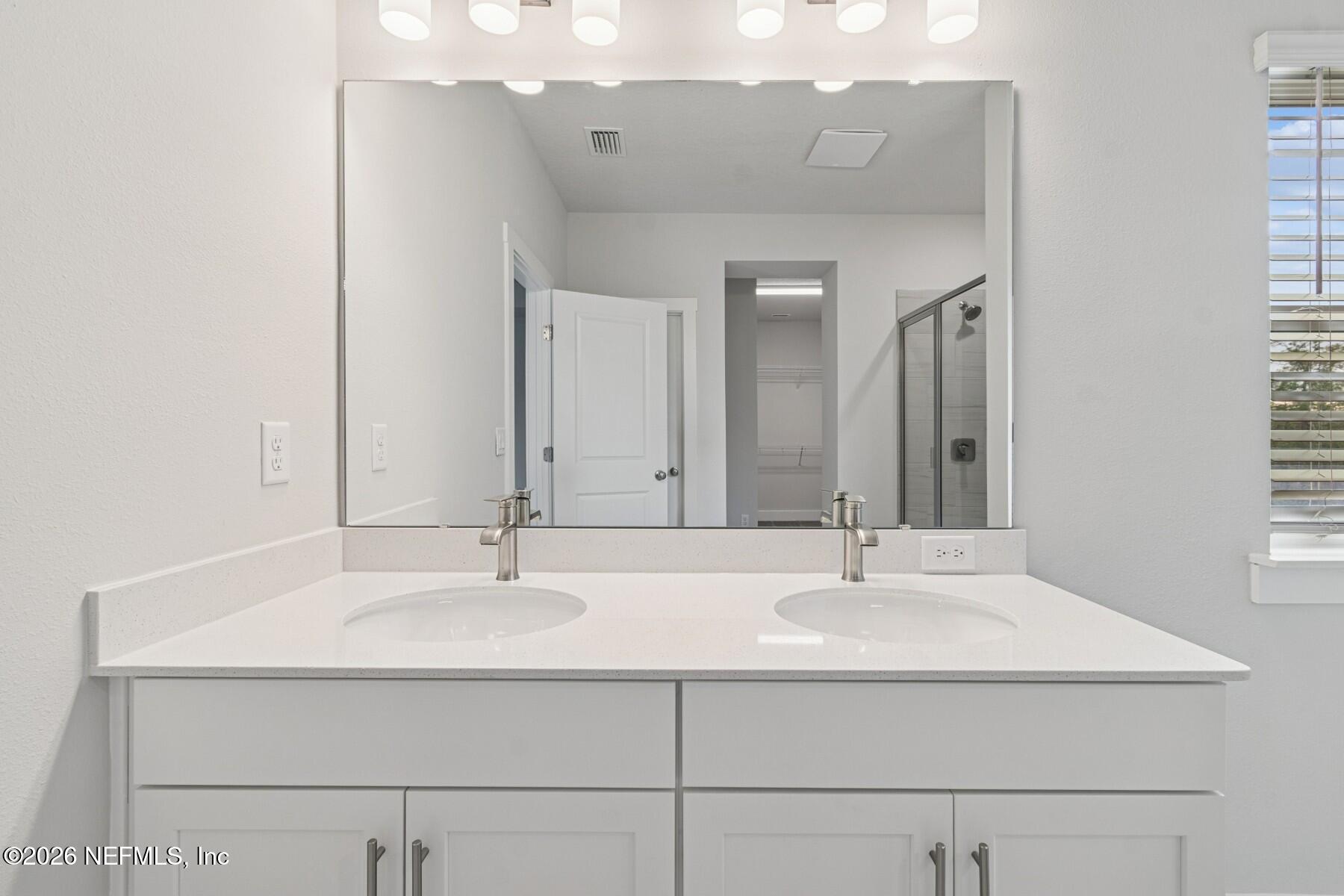 10131 Element Road Jacksonville, FL 32256 - Photo 23 of 28 a bathroom with a sink and a mirror