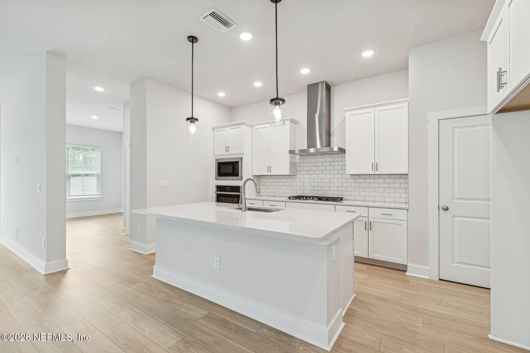 10131 Element Road Jacksonville, FL 32256 - Photo 3 of 28 a large kitchen with stainless steel appliances kitchen island wooden cabinets and a granite counter tops