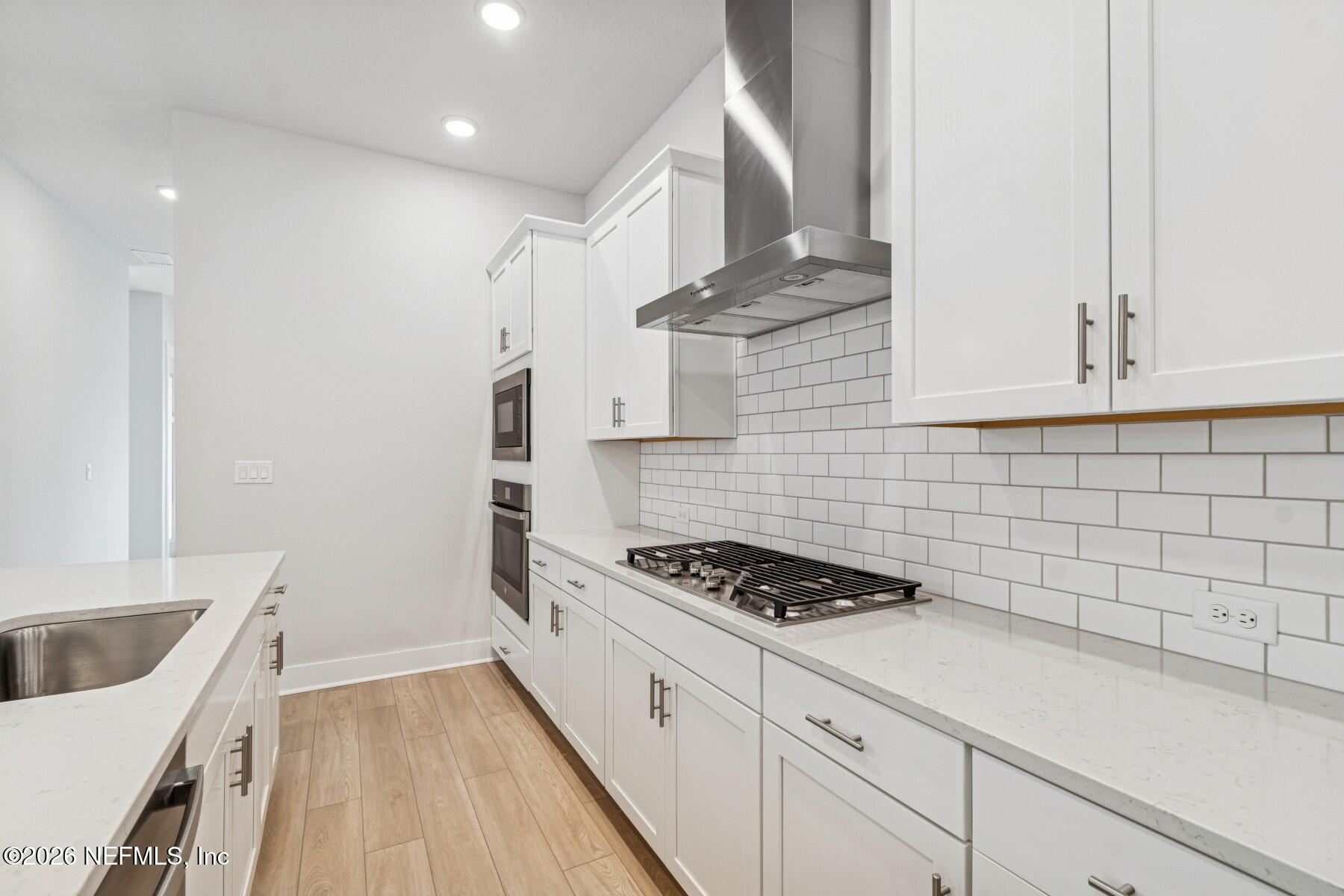 10131 Element Road Jacksonville, FL 32256 - Photo 4 of 28 a kitchen with granite countertop a sink stove and cabinets