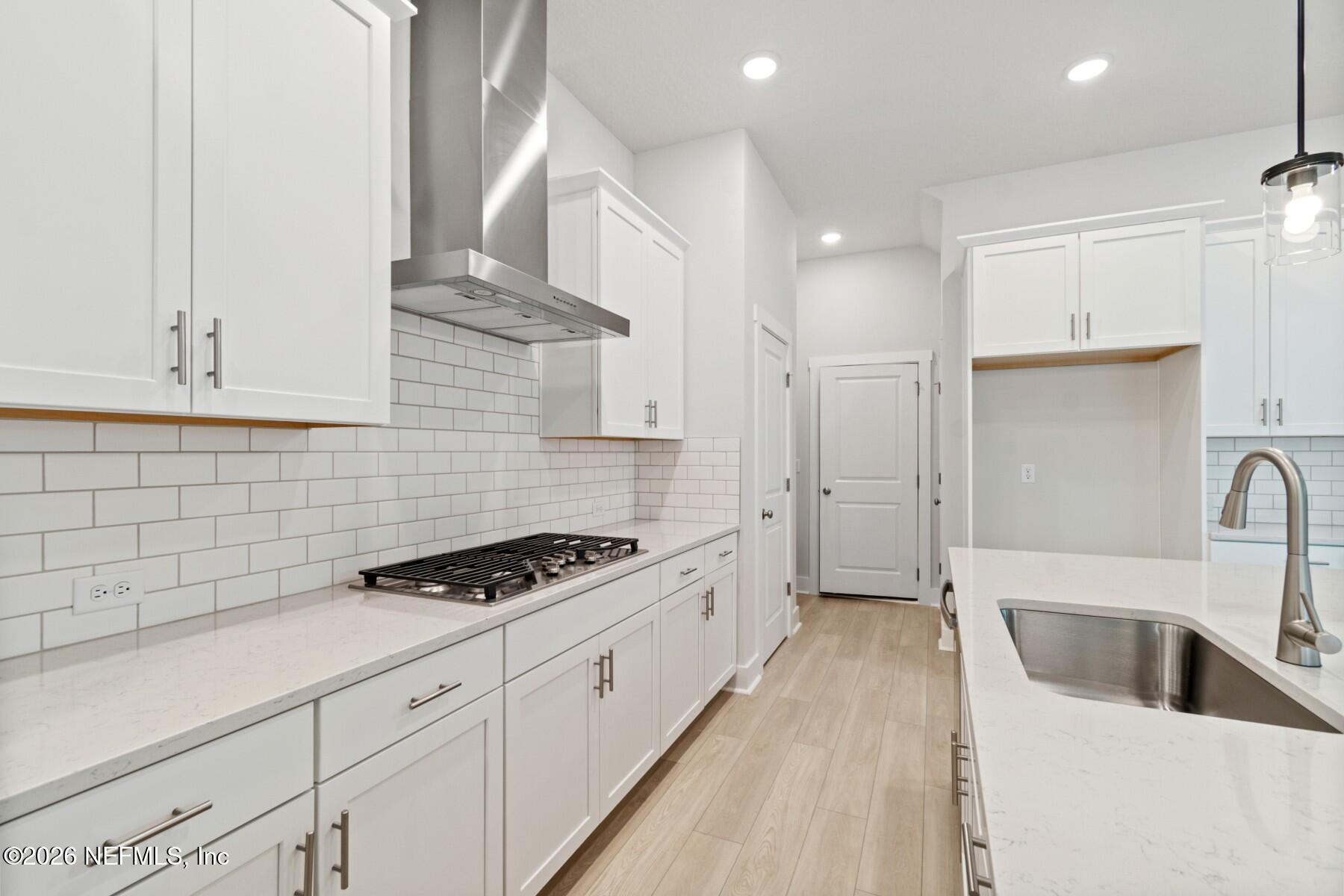 10131 Element Road Jacksonville, FL 32256 - Photo 5 of 28 a kitchen with granite countertop a sink a stove and refrigerator