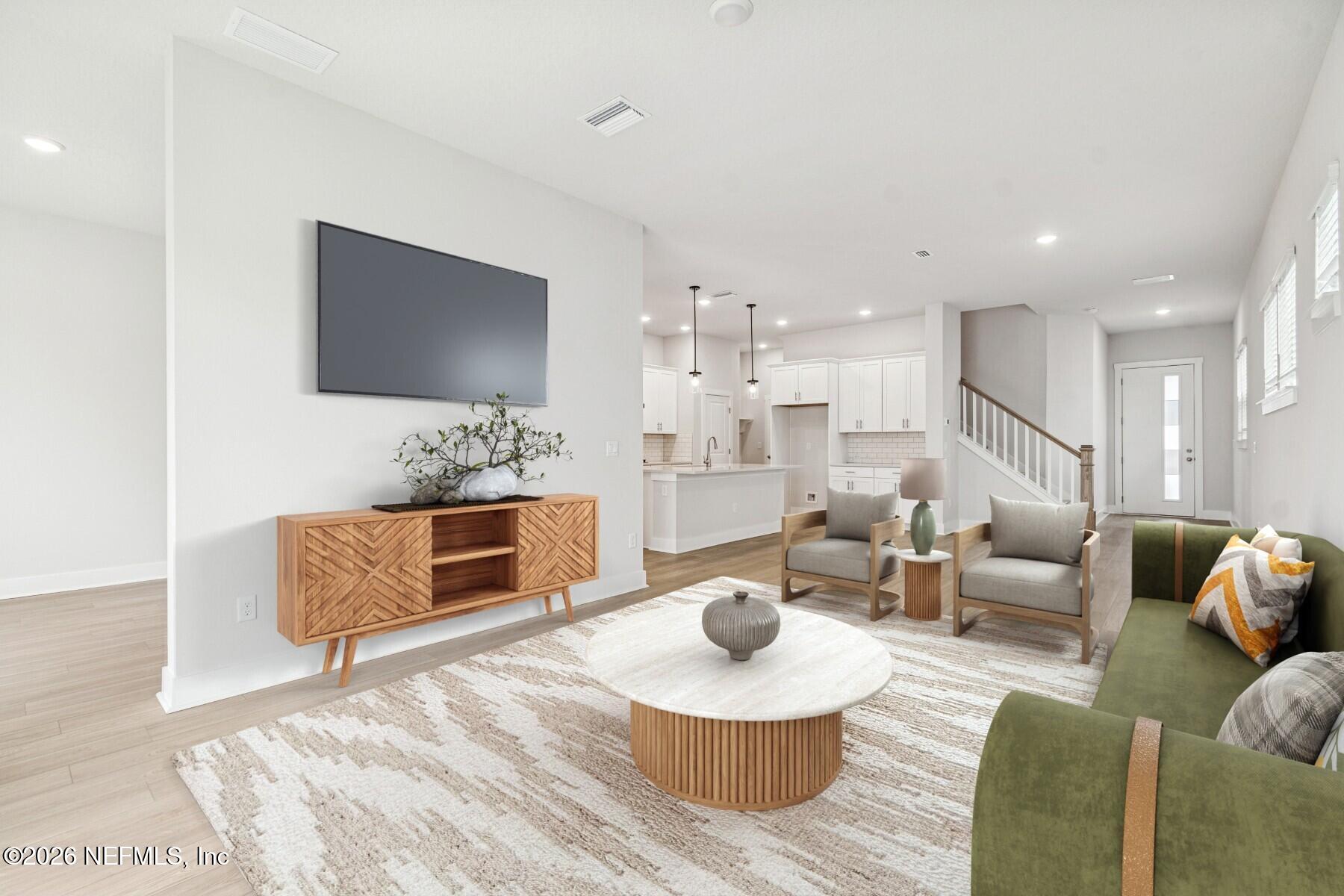 10131 Element Road Jacksonville, FL 32256 - Photo 8 of 28 a living room with furniture and a flat screen tv