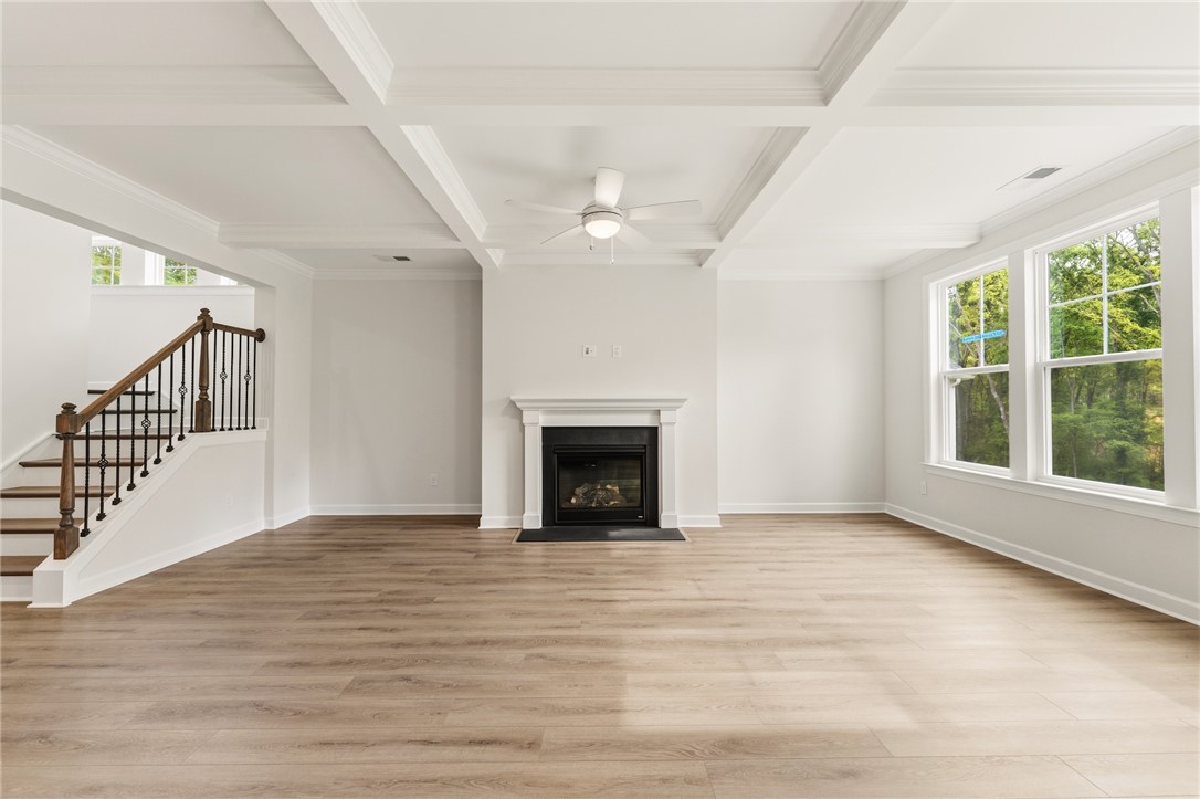 1108 Manse Jolly Road Anderson, SC 29621 - Photo 15 of 45 This living room features elegant coffered ceilings, a cozy fireplace, and abundant natural light.