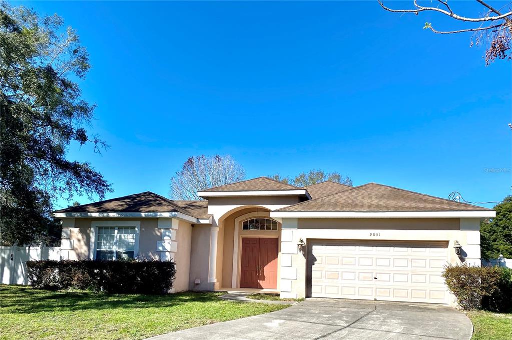 9031 Jena Road Spring Hill, FL 34608 - Photo 1 of 1 a front view of a house with a garden and yard