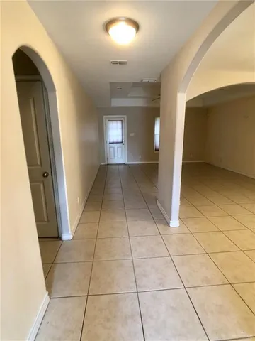 a view of a hallway to rooms and stairs
