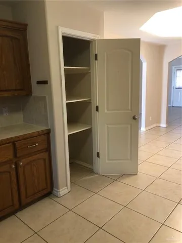 a view of an empty room and closet area