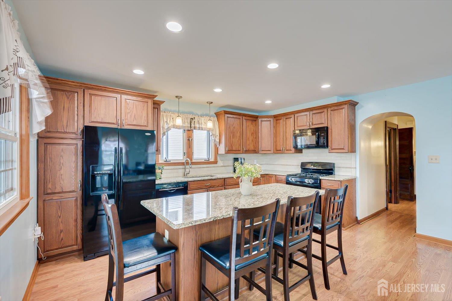 620 Dunellen Avenue Dunellen, NJ 08812 - Photo 14 of 48 a kitchen with stainless steel appliances granite countertop a dining table chairs refrigerator and microwave