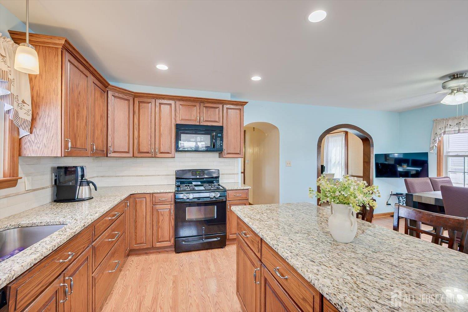 620 Dunellen Avenue Dunellen, NJ 08812 - Photo 17 of 48 a kitchen with stainless steel appliances granite countertop a stove top oven a sink dishwasher and cabinets with wooden floor