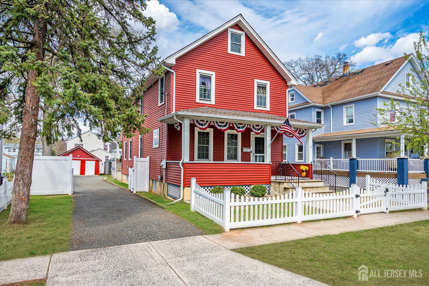620 Dunellen Avenue Dunellen, NJ 08812 - Photo 2 of 48 a front view of a house with a yard table and chairs