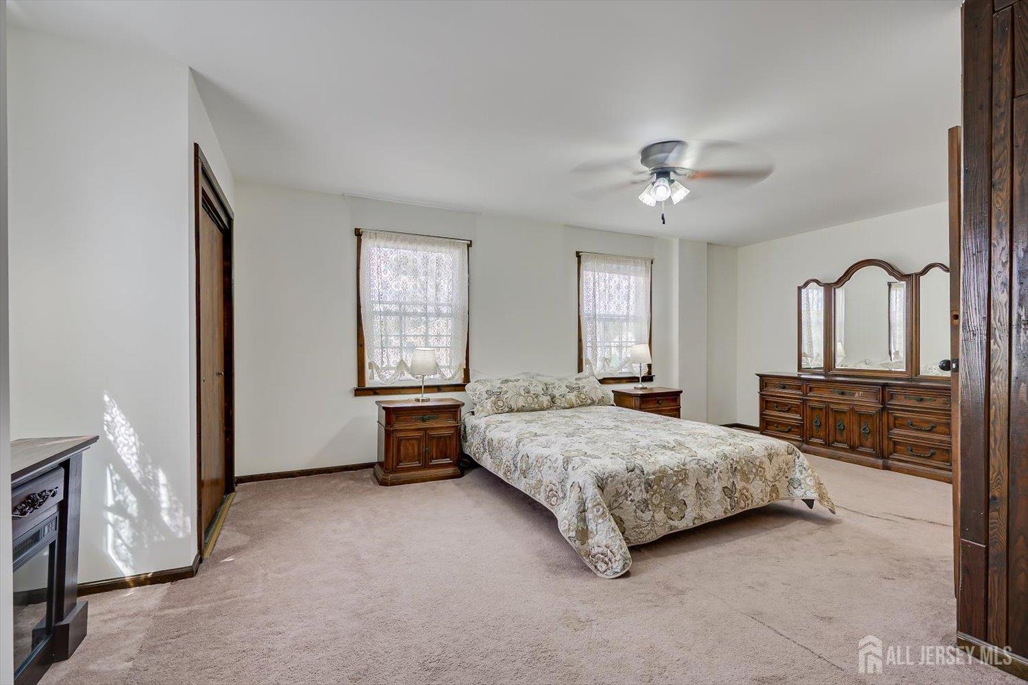 620 Dunellen Avenue Dunellen, NJ 08812 - Photo 21 of 48 a spacious bedroom with a bed chandelier and windows