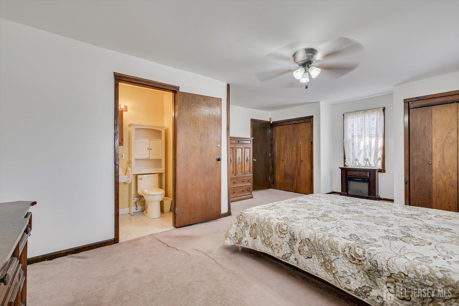 620 Dunellen Avenue Dunellen, NJ 08812 - Photo 23 of 48 a bedroom with a large bed and a chandelier