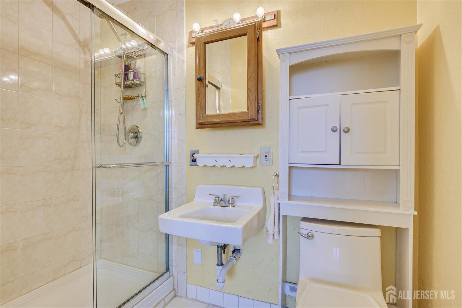 620 Dunellen Avenue Dunellen, NJ 08812 - Photo 24 of 48 a bathroom with a sink and a mirror