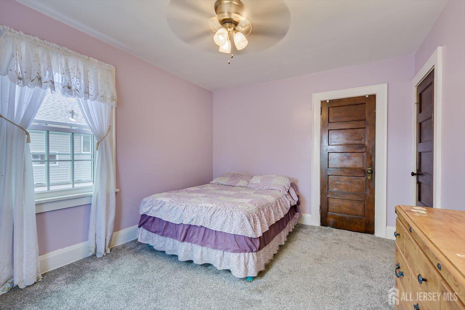 620 Dunellen Avenue Dunellen, NJ 08812 - Photo 27 of 48 a spacious bedroom with a bed and a window