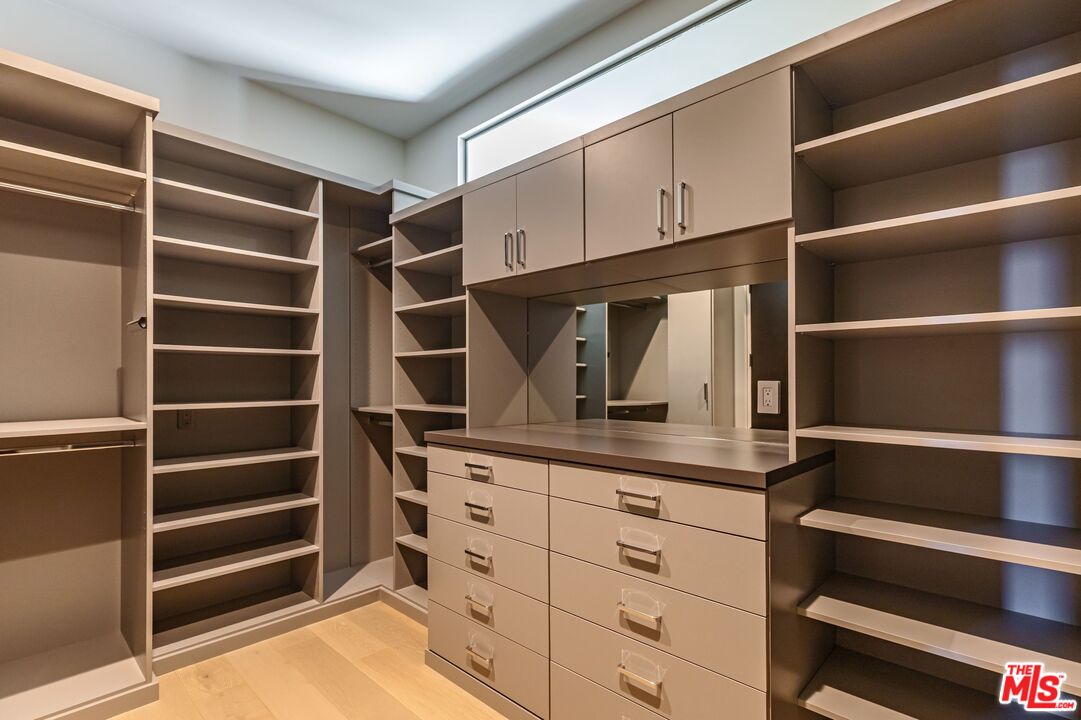 1895 Rising Glen Road Los Angeles, CA 90069 - Photo 15 of 41 a view of walk in closet with empty racks