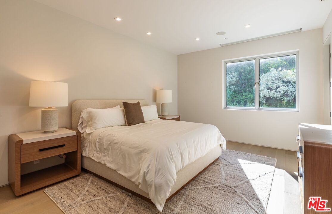 1895 Rising Glen Road Los Angeles, CA 90069 - Photo 19 of 41 a bedroom with a bed and a window
