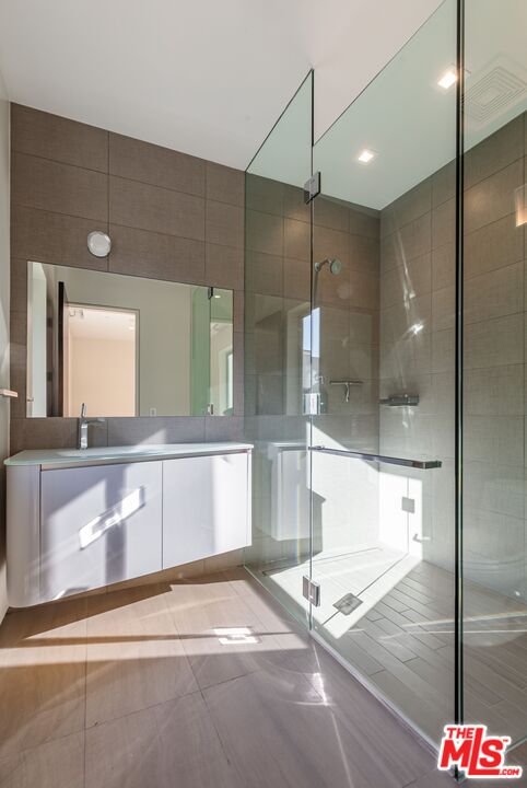 1895 Rising Glen Road Los Angeles, CA 90069 - Photo 22 of 41 a bathroom with a granite countertop sink mirror and bathtub