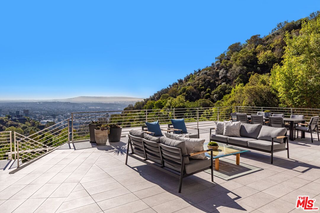1895 Rising Glen Road Los Angeles, CA 90069 - Photo 30 of 41 a terrace with outdoor seating and trees