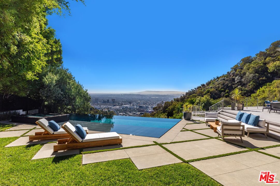1895 Rising Glen Road Los Angeles, CA 90069 - Photo 32 of 41 a view of a patio with chairs and plants