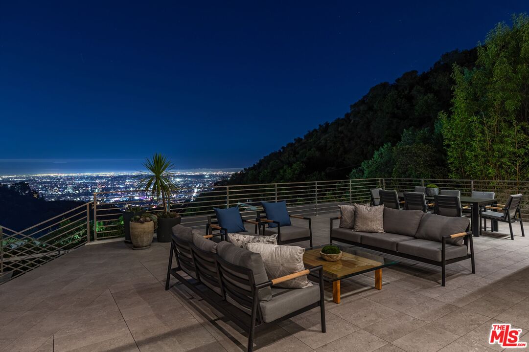 1895 Rising Glen Road Los Angeles, CA 90069 - Photo 36 of 41 a view of a roof deck with couches and potted plants