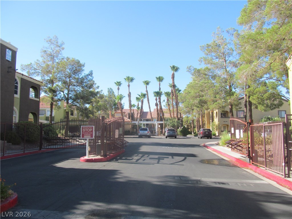7950 West Flamingo Road, Unit 2048 Las Vegas, NV 89147 - Photo 1 of 24 Secure community entry welcomes you with a classic wrought iron gate and lush palms.