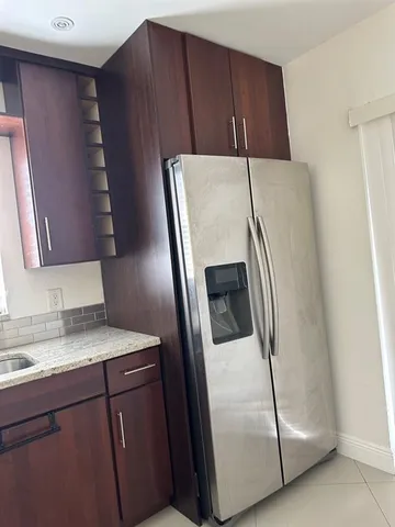 a kitchen with a refrigerator and cabinets