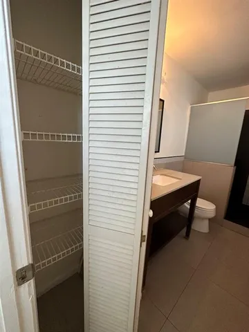 a view of a room with rack on the wall and a window