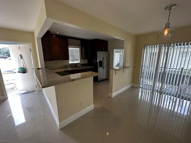 a kitchen with sink and refrigerator