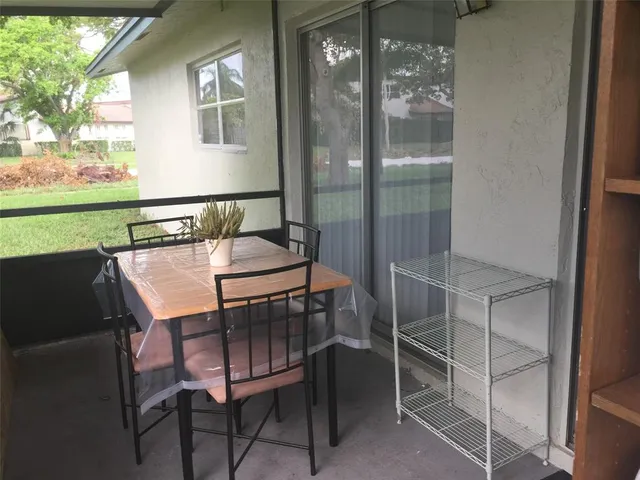 a balcony with table and chairs