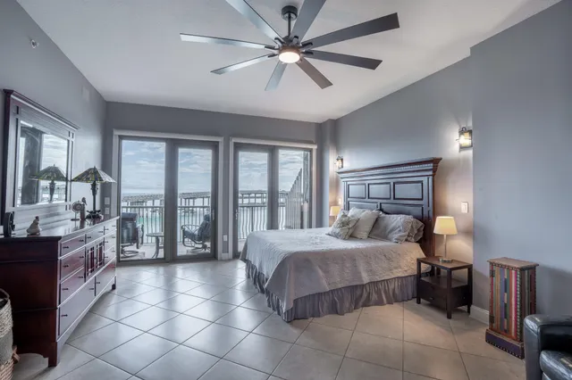 a bedroom with a large bed and a chandelier