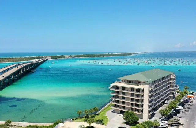 a living room with furniture a flat screen tv and a large window