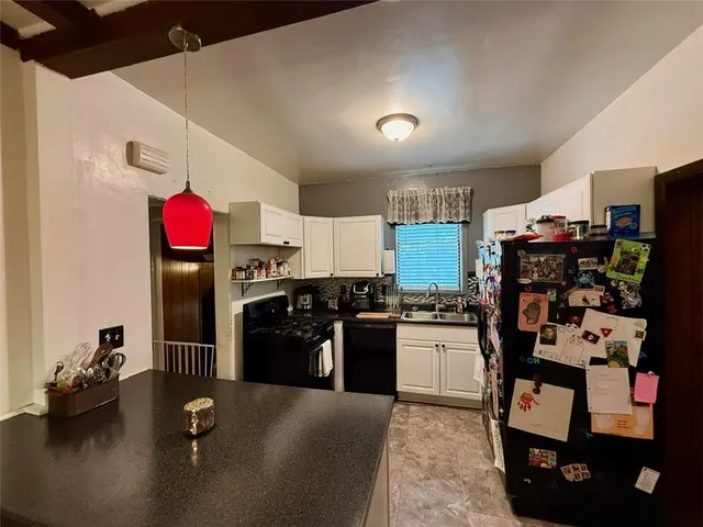 a kitchen with refrigerator and cabinets