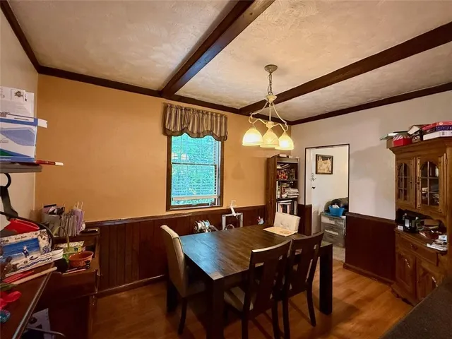 a view of a dining room with furniture and window