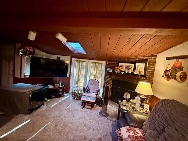 a living room with furniture a flat screen tv and a window