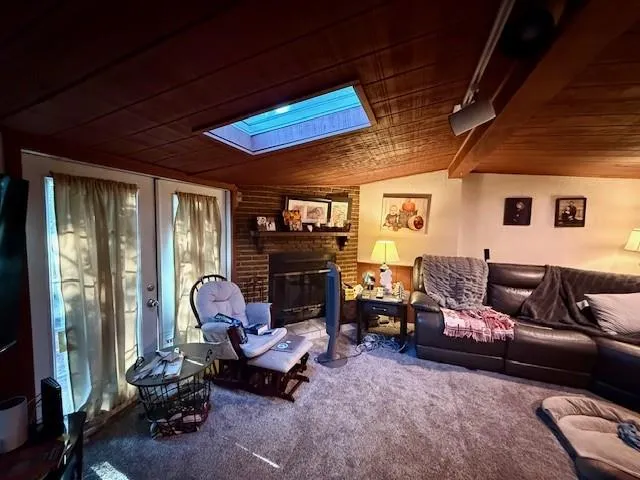 a living room with furniture a rug and a large window