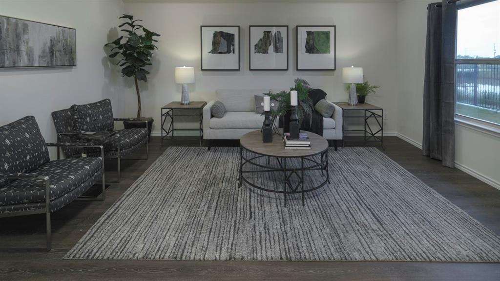 3100 Charleston Drive Ennis, TX 75119 - Photo 17 of 23 Spacious living area featuring dark wood-finish flooring