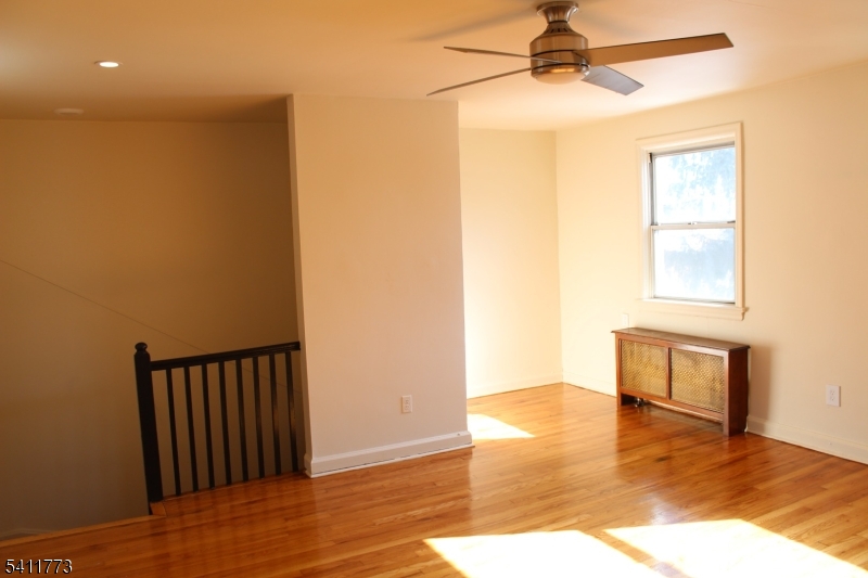 364 Orange Road, Unit B18 Montclair, NJ 07042 - Photo 2 of 9 a view of empty room with wooden floor and fan
