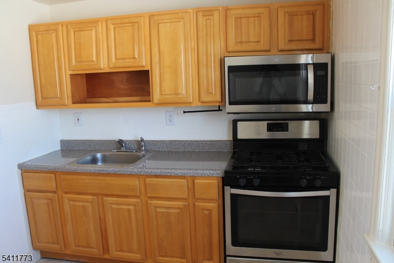 364 Orange Road, Unit B18 Montclair, NJ 07042 - Photo 4 of 9 a kitchen with appliances a sink and cabinets