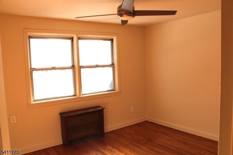 364 Orange Road, Unit B18 Montclair, NJ 07042 - Photo 6 of 9 an empty room with wooden floor and windows