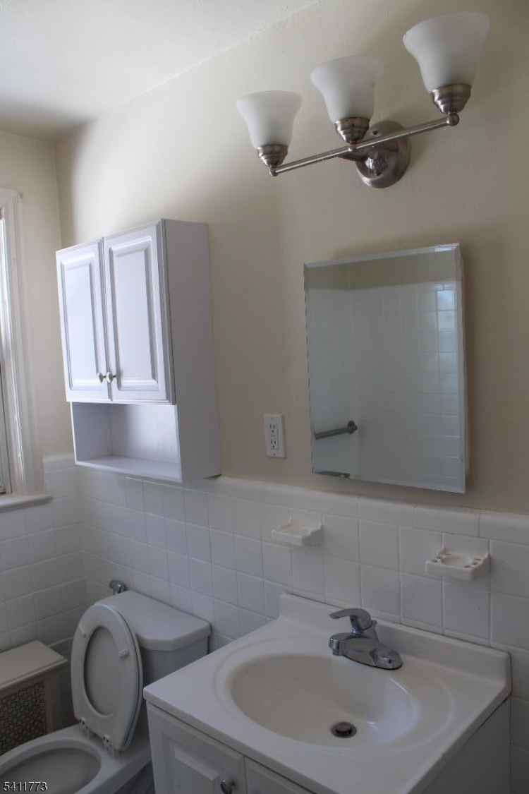 364 Orange Road, Unit B18 Montclair, NJ 07042 - Photo 8 of 9 a bathroom with a sink mirror and toilet