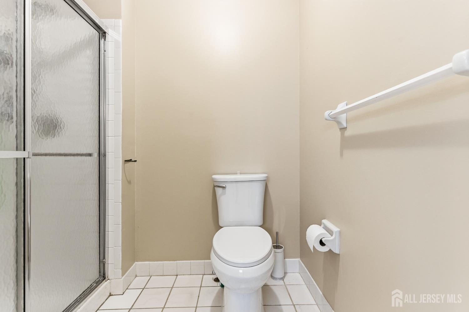 21 Newburgh Drive Edison, NJ 08820 - Photo 18 of 31 a bathroom with a toilet and a shower curtain