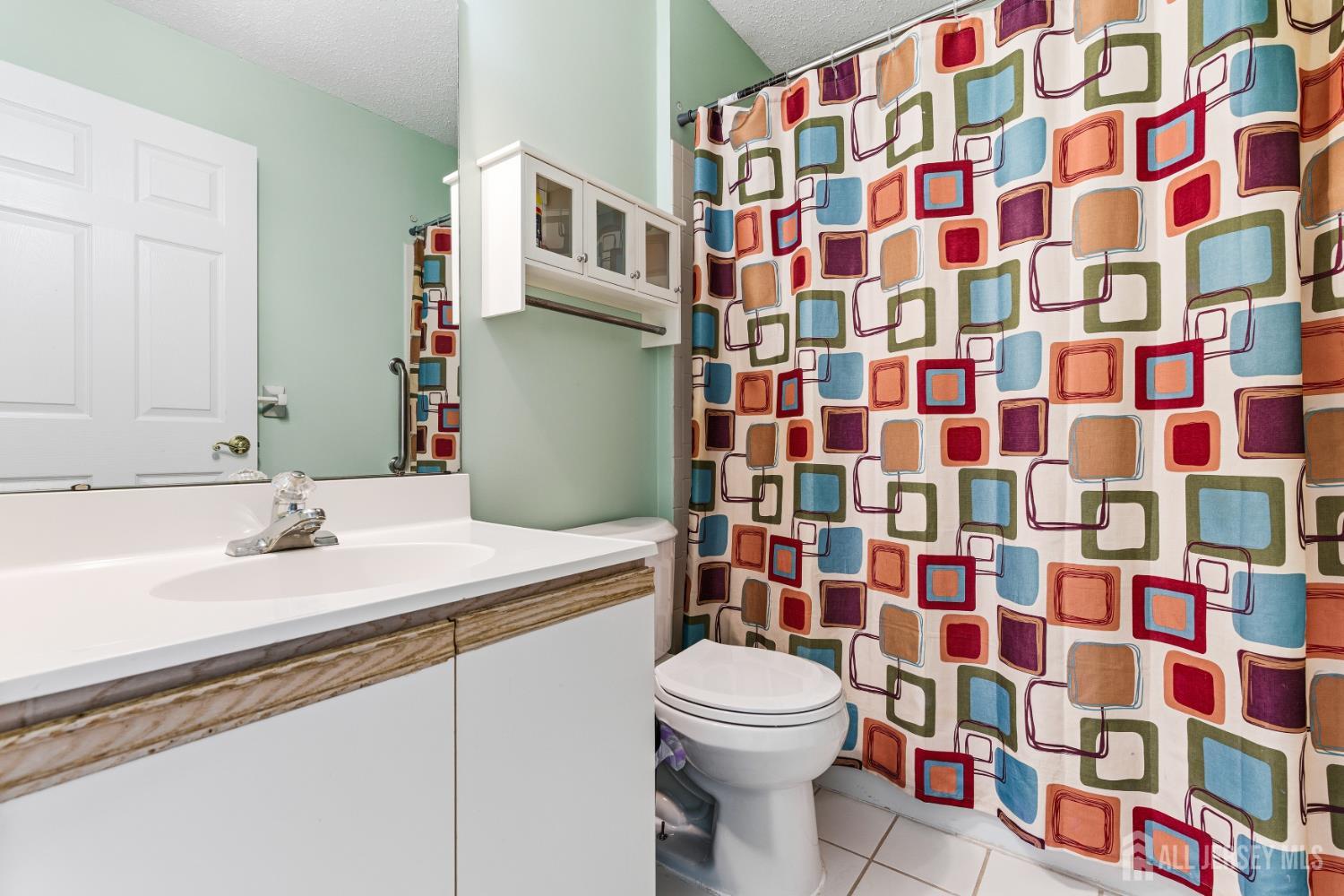 21 Newburgh Drive Edison, NJ 08820 - Photo 21 of 31 a bathroom with a sink toilet and shower